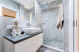 a bathroom with a sink and a shower at Apartmán Ostrava in Ostrava
