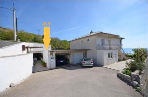 a house with a car parked in a driveway at Milojka in Senj +17 photos