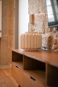 a cake sitting on top of a wooden dresser at Oporto Chic&Cozy - Ribeira in Porto +97 photos