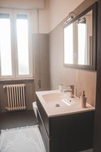 a bathroom with a sink and a mirror at NOVA DOMUS FLAT Free Private Parking in Siena