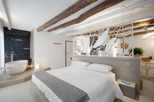 a white bedroom with a large bed and a bathroom at Life Class Apartment in Riomaggiore