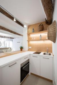 a kitchen with white cabinets and a sink at Life Class Apartment in Riomaggiore