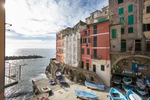 a group of buildings next to the water at Life Class Apartment in Riomaggiore