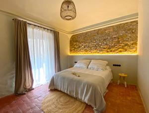 a bedroom with a bed and a painting on the wall at Casa Elvira in Torroella de Montgrí