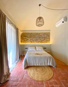 a bedroom with a bed and a large window at Casa Elvira in Torroella de Montgrí