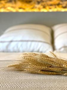 a stack of wheat on a bed at Casa Elvira in Torroella de Montgrí