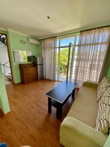 a living room with a couch and a table at Green Hotel Ureki in Ureki