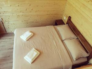 a bedroom with a bed with two pillows on it at Cabana Bahna in Iloviţa