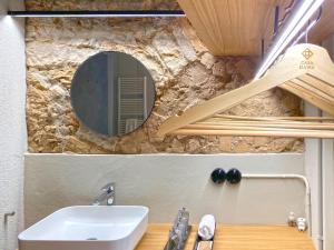 a bathroom with a sink and a mirror on the wall at Casa Elvira in Torroella de Montgrí