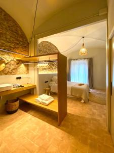 a bedroom with a bed and a sink and a mirror at Casa Elvira in Torroella de Montgrí