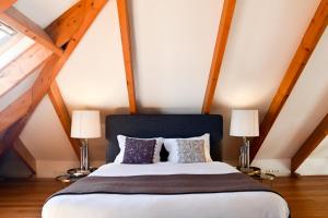 a bedroom with a large bed with two lamps at Oporto Chic&Cozy - Ribeira in Porto