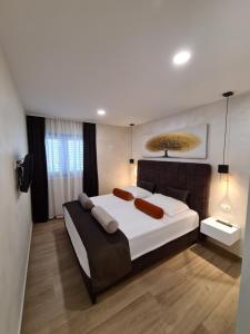 a large bedroom with a large bed and a television at Apartman Kamena 67 A in Tučepi
