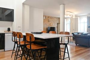 a kitchen and living room with a table and chairs at Oporto Chic&Cozy - Ribeira in Porto