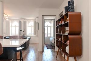 a kitchen and living room with a book shelf at Oporto Chic&Cozy - Ribeira in Porto