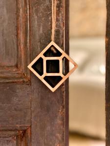 a wooden door with a honeycomb on it at Casa Elvira in Torroella de Montgrí