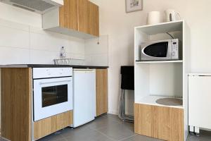 a kitchen with white appliances and a microwave at The ingenious blue #BS in Grenoble