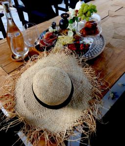 a straw hat sitting on top of a wooden table at Casa BOHO in Alaminos