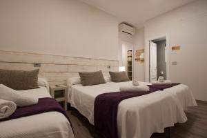 a bedroom with two beds with towels on them at Pensión San Martin in San Sebastián