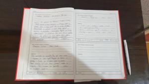 an open book with handwriting on the pages at APARTMANI STARI GRAD PRIBOJ in Priboj