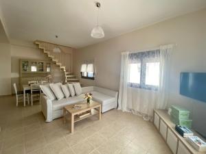 a living room with a couch and a table at Rebekka's HOUSE in Zekros