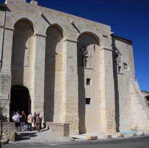 a group of people standing outside of a building at L'atelier in Capestang