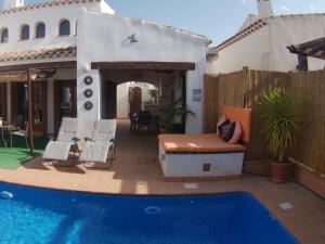 a backyard with a pool and a house at Casa Calida in Murcia