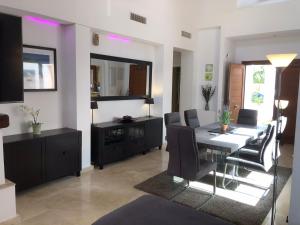 a living room with a dining room table and chairs at Casa Calida in Murcia