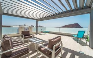 a patio with chairs and a view of the ocean at Tejita beach , The beach dream flats in Granadilla de Abona