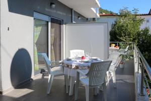 a table and four chairs on a balcony with a table and chairsktop at Villa Riki in Živogošće +15 photos