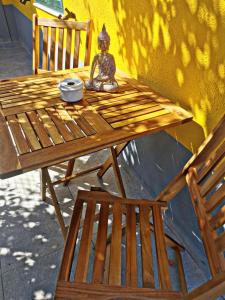 a wooden table with a statue sitting on top of it at Quinta do Pica-Pau Amarelo in Grândola