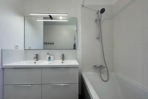 a white bathroom with a sink and a shower at Recent house in a hamlet near the Cher in Athée-sur-Cher +32 photos