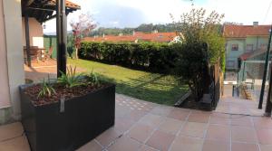 a patio with a garden with plants in a yard at playa ribadesella kety in Ribadesella