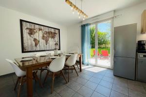 a kitchen and dining room with a table and chairs at New house in the heart of a hamlet near Amboise and Chenonceaux in Athée-sur-Cher