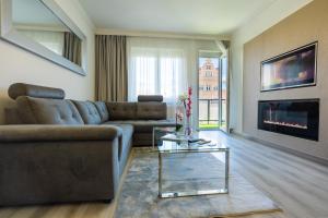 a living room with a couch and a fireplace at Central Residence in Sopron