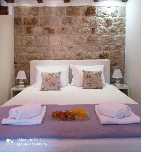 a bed with towels and a tray of food on it at Studio Makala in Trogir