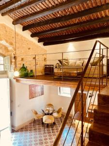a loft conversion with a bed and a table and chairs at O'scià Loft in Noto