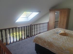 a bedroom with a bed and a skylight at B&B De Horizon in Urk