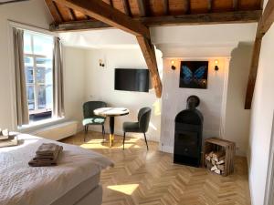 a bedroom with a bed and a wood stove at The Harbour Leiden in Leiden