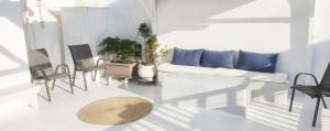 a white living room with a white couch and chairs at Bougainvillea Typical Town House - Private Rooftop in Mikonos