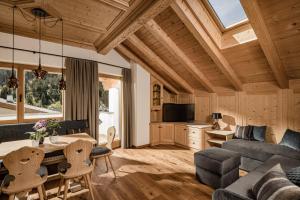 a living room with a couch and a table at Apartments Belaval in Santa Cristina in Val Gardena