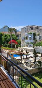 a view of a resort with a pool and buildings at Nicoll Apartments in Acharavi