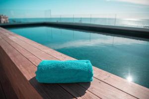 a blue towel sitting on top of a wooden bench at Hotel Port Toga in Bastia