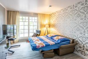 a bedroom with a bed and a television in it at Ferienwohnungen auf Rügen in Binz