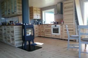 a kitchen with a stove in the middle of it at Ro i Steigen in Steigen
