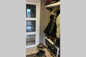 a walk in closet with shoes on the shelves at See Lofoten mountains midnight sun and nothern lights in Steigen in Steigen +30 photos