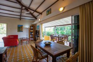 a living room with a wooden table and chairs at Bungalow Hopi Bon in Willemstad