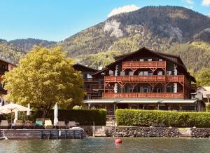 a large building with a boat on top of it at Strandhotel Margaretha in St. Wolfgang
