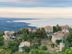a small town with a view of the water at villa chez marie Meuble tourisme 3 etoiles in Sari Solenzara