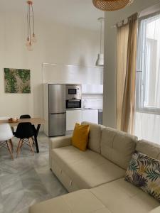 a living room with a couch and a table at Apartamento nuevo en casa tipo palacio in Cádiz