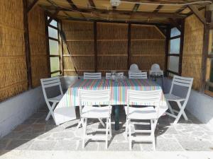 a dining table and chairs in a tent at Casa Ananda in Sorso